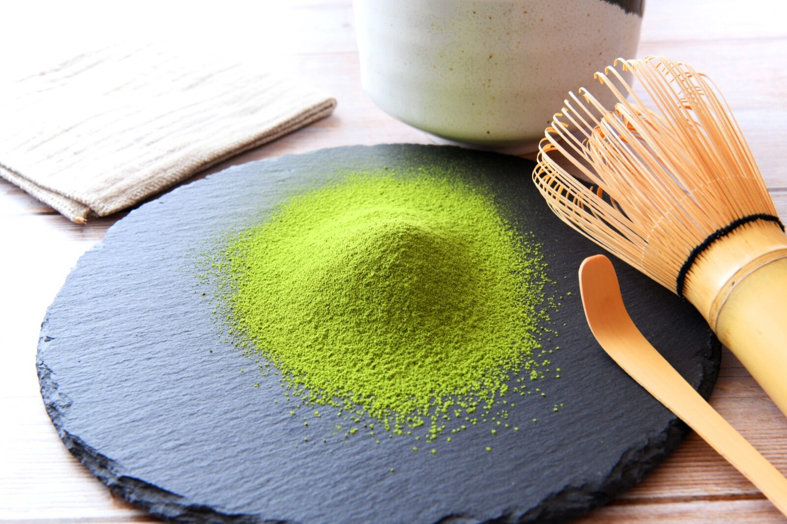 Matcha powder with a bamboo whisk and tea bowl